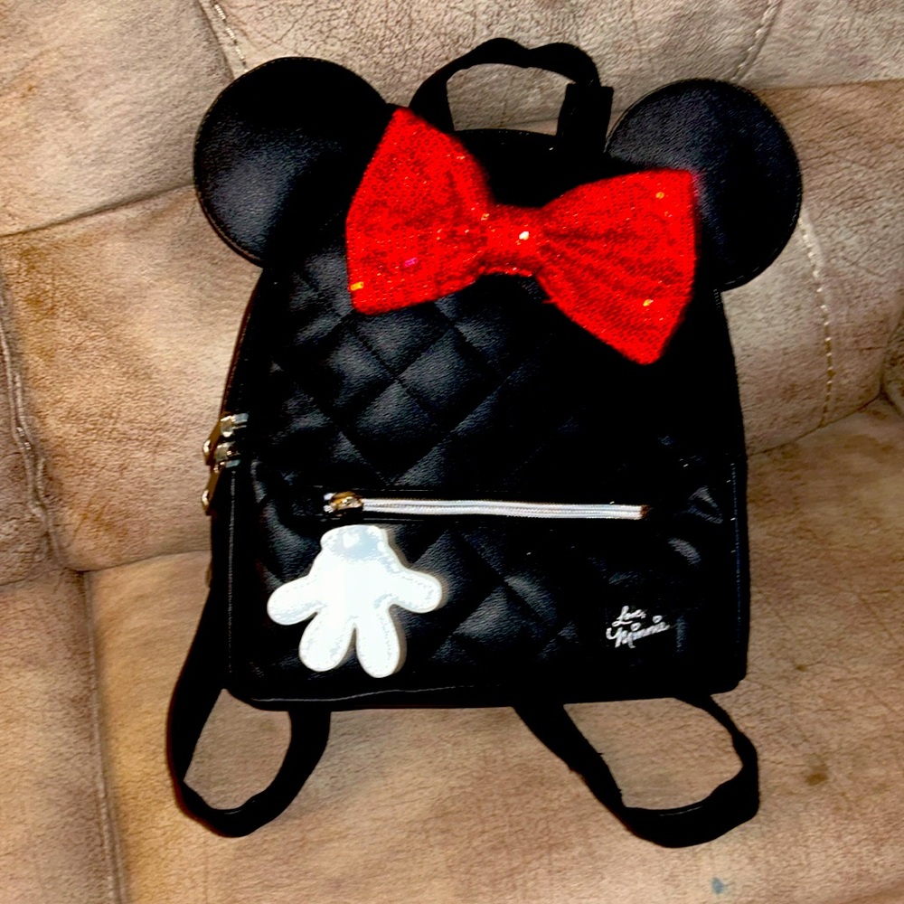 Leather backpack, a medium size black red bone on it, Minnie mouse